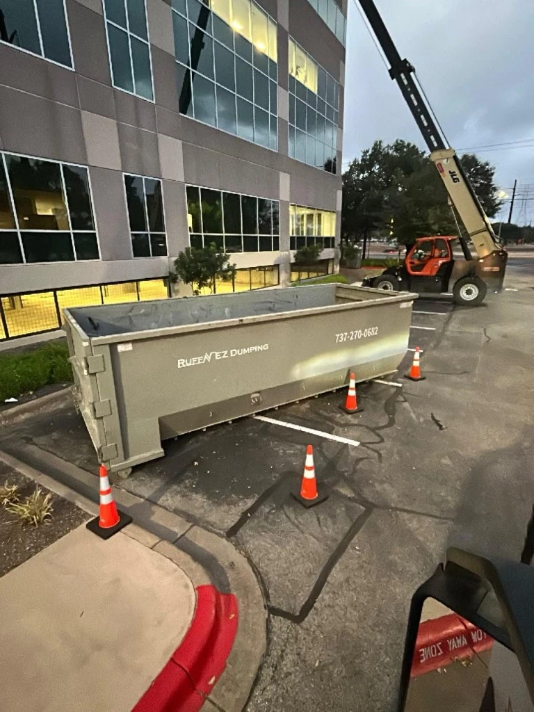 Roll-off dumpster safe placement with traffic cones at commercial complex